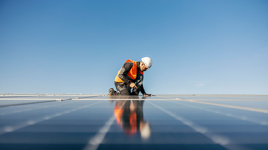 man working on solar panel